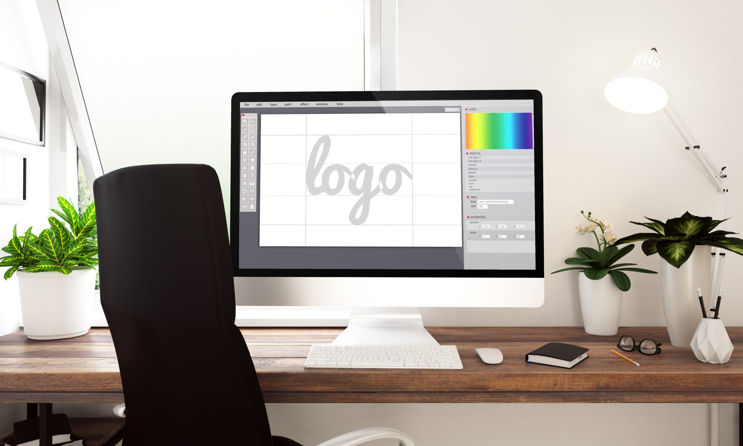 Environnement de travail, vue d'un ordinateur axée sur la création graphique d'un logo et de sa colorimétrie